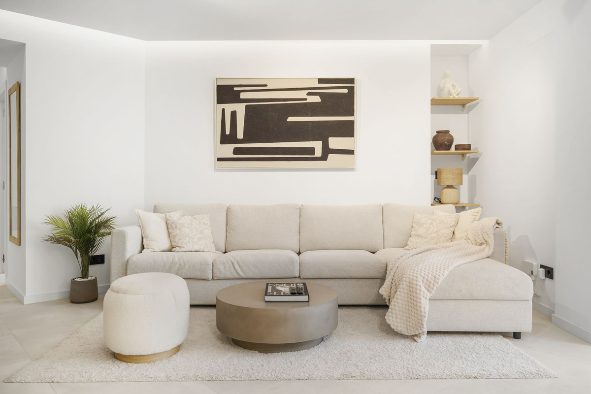 Living room with corner sofa, artwork and built-in oak shelving