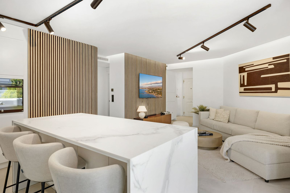 Kitchen island with breakfast seating facing the living area