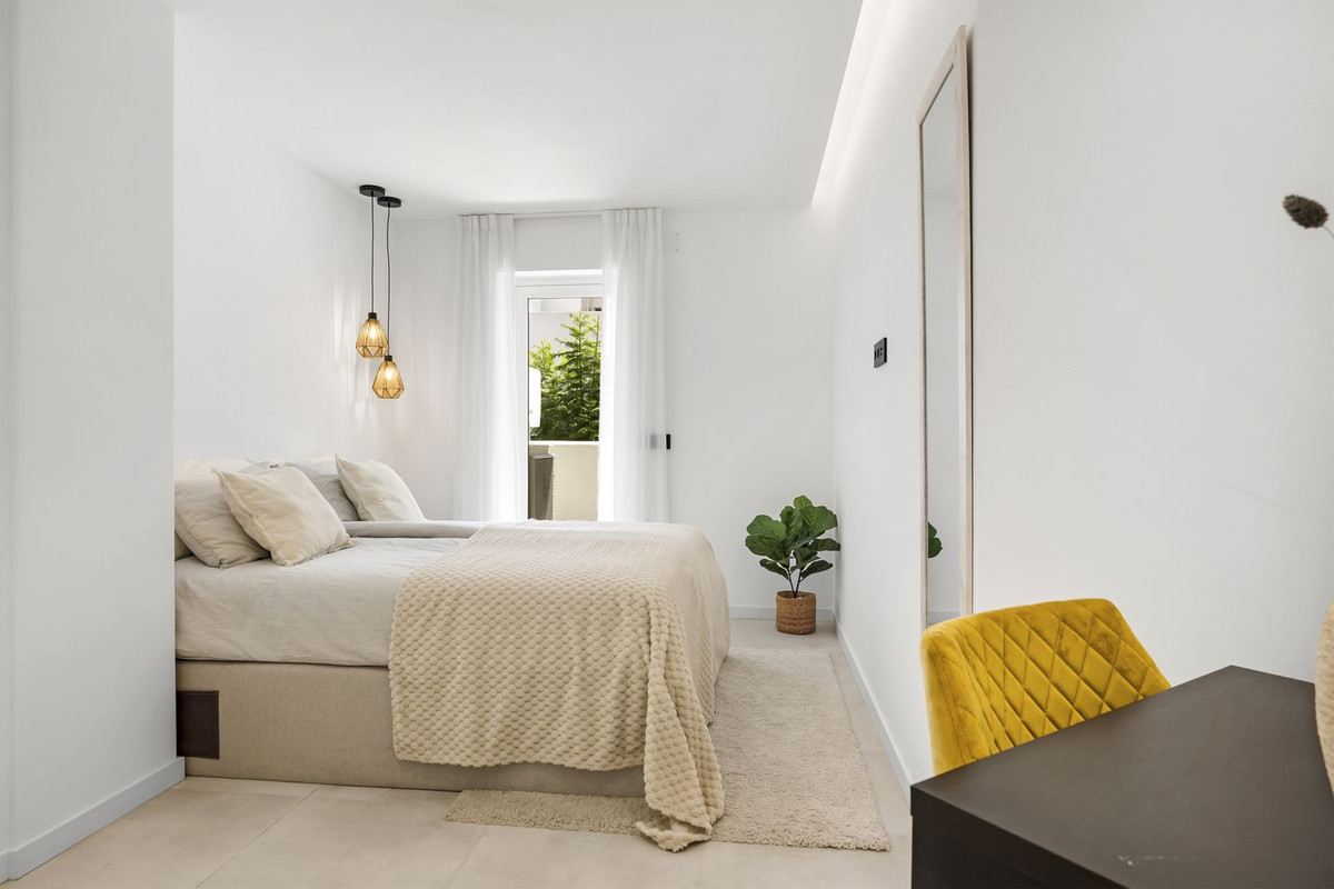 Third bedroom with pendant lighting and desk area