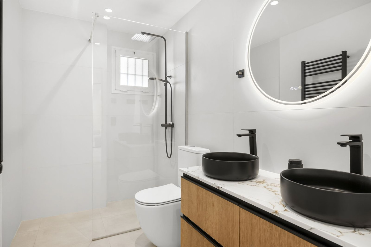Second bathroom with walk-in shower and twin basins