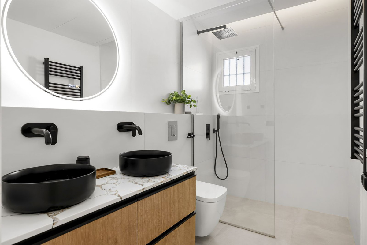 Renovated bathroom with double vessel basins, marble top and walk-in rain shower
